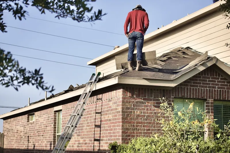 Professional roofer working on a residential roof in Fort Herriman